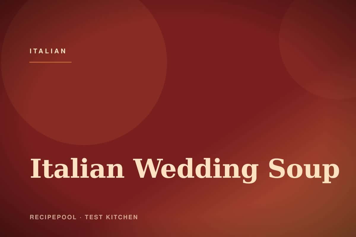 Bowl of Italian wedding soup with mini meatballs, pasta, and greens
