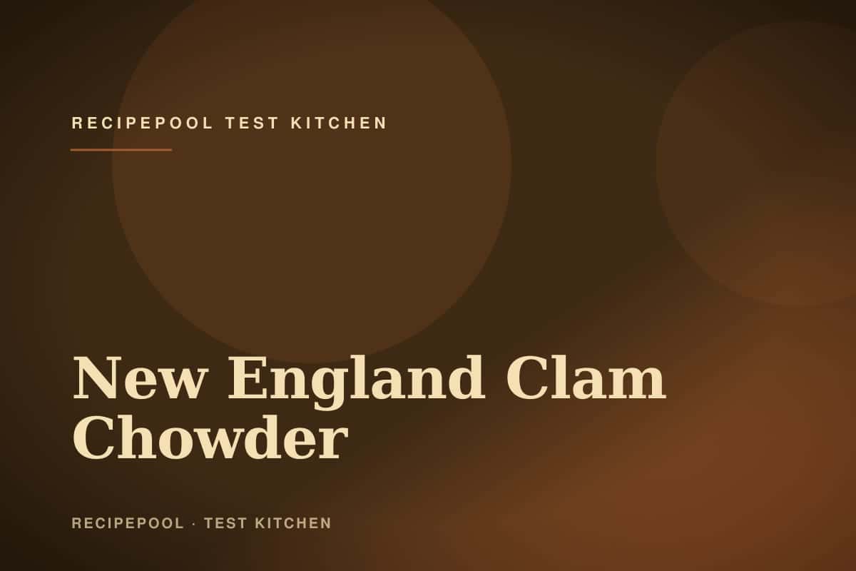 Bowl of creamy New England clam chowder topped with crackers and fresh chives
