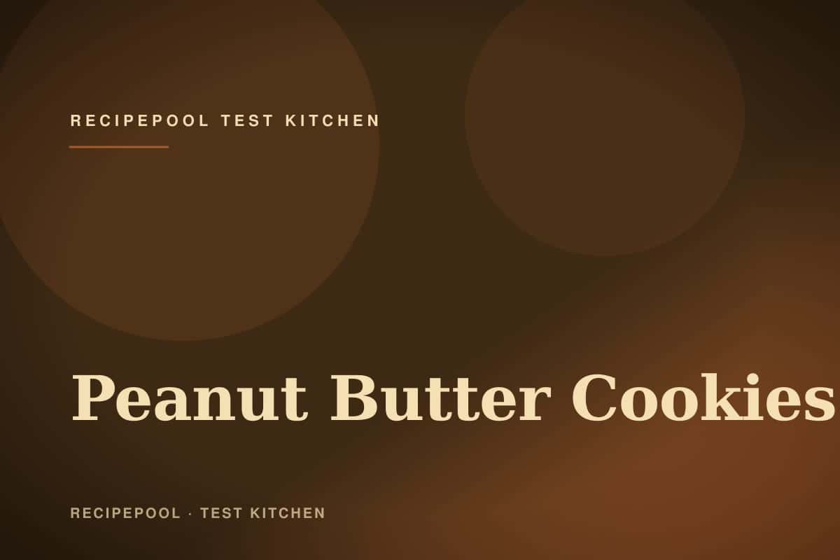 Peanut butter cookies with classic crosshatch pattern on a baking sheet