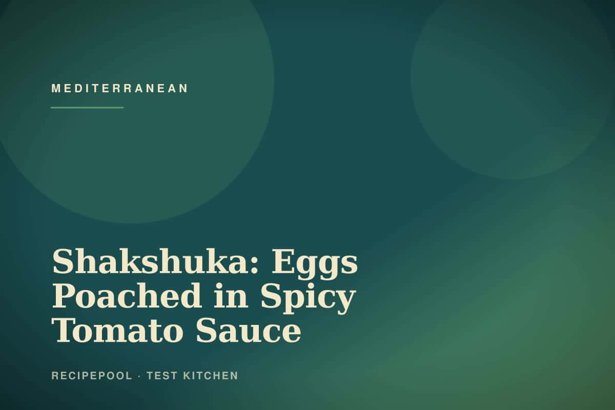 Skillet of shakshuka with eggs poached in spicy tomato sauce topped with fresh herbs