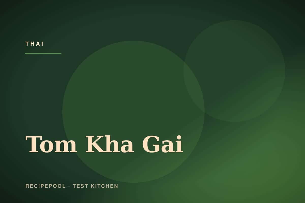 Bowl of creamy tom kha gai soup with mushrooms, cilantro, and red chilies