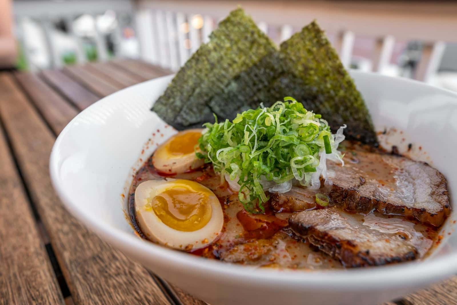 Tonkotsu ramen bowl with chashu pork, soft-boiled egg, noodles, scallions, and nori