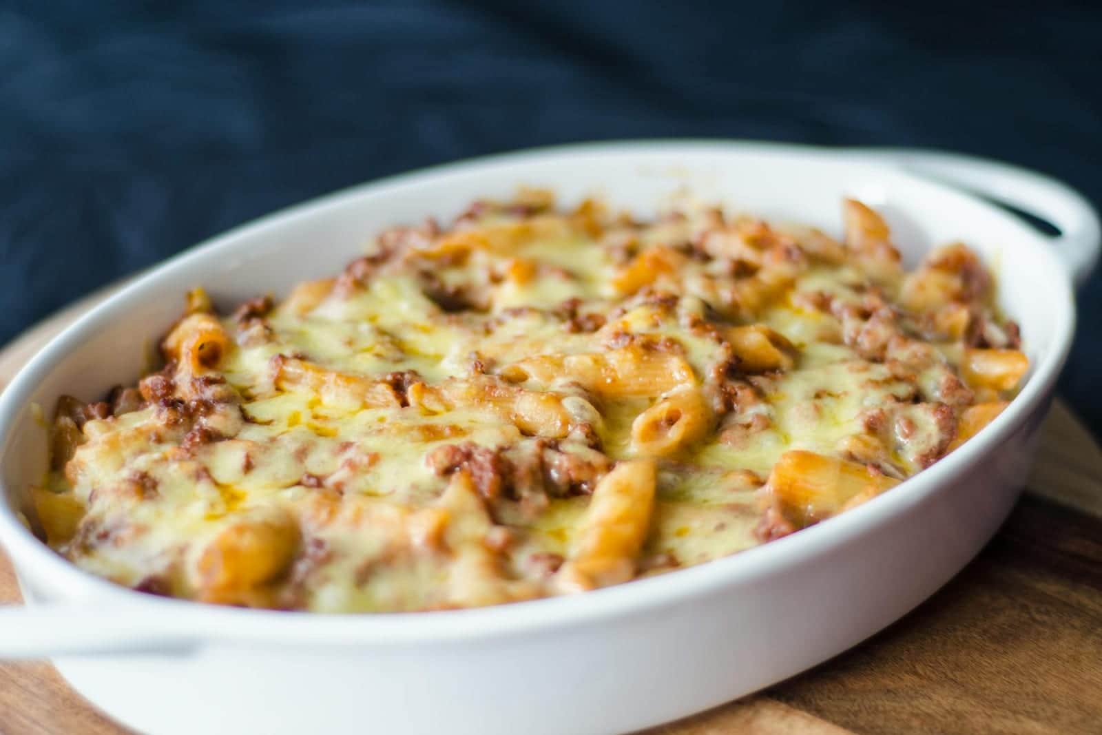 Baked mac and cheese casserole with browned cheese and pasta in a white baking dish