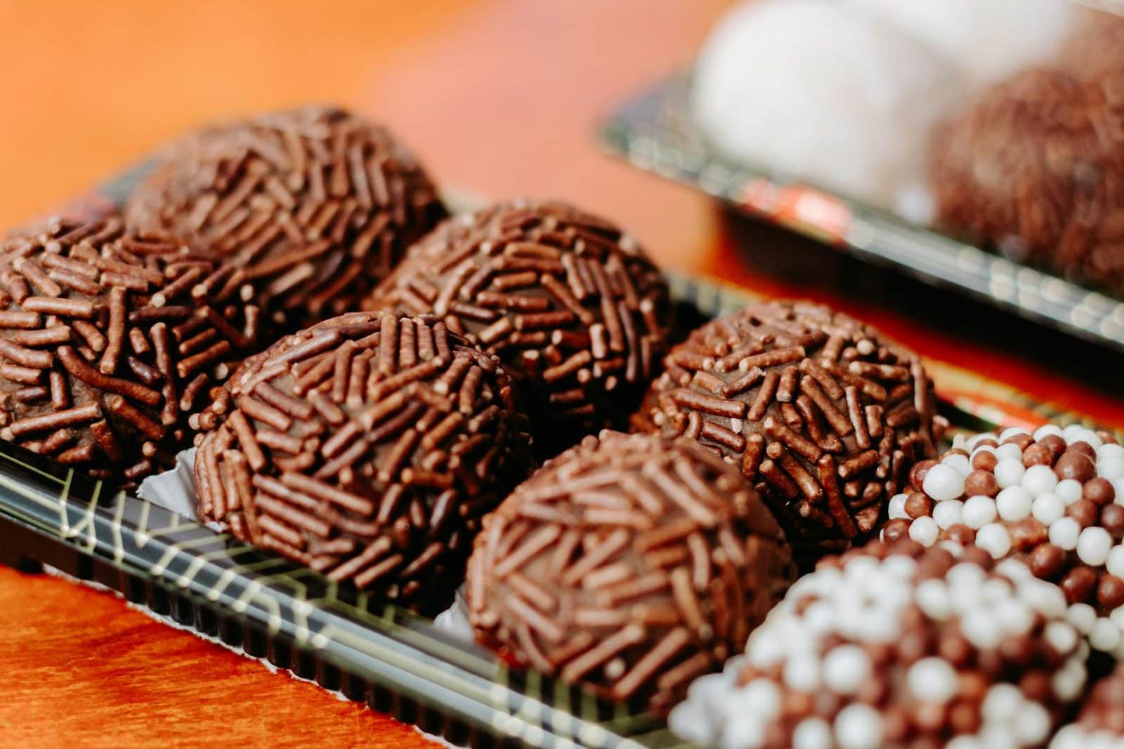 Brigadeiros chocolate truffles coated in sprinkles and arranged for serving