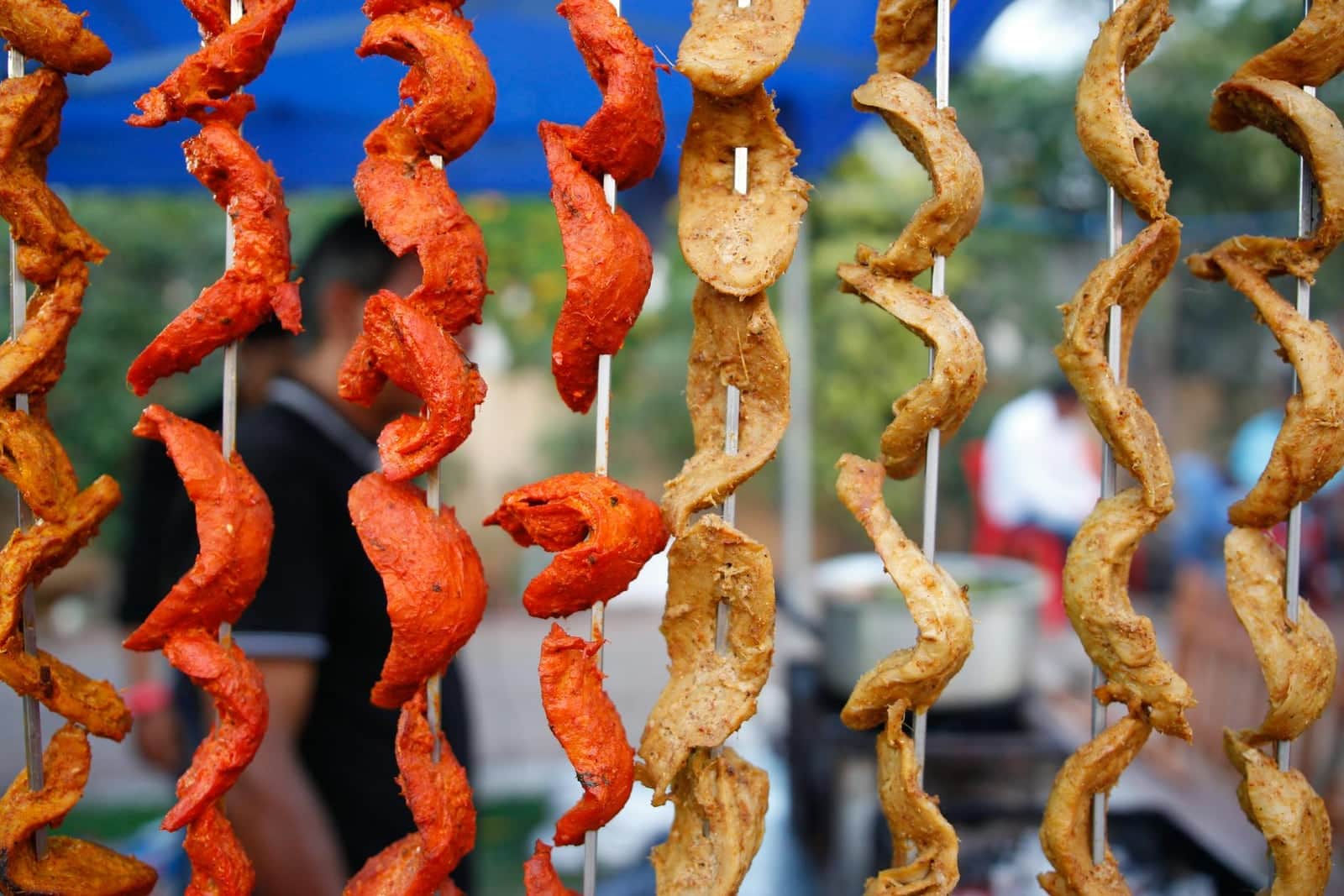 Chicken tikka skewers with red-orange spiced chicken pieces cooked on skewers