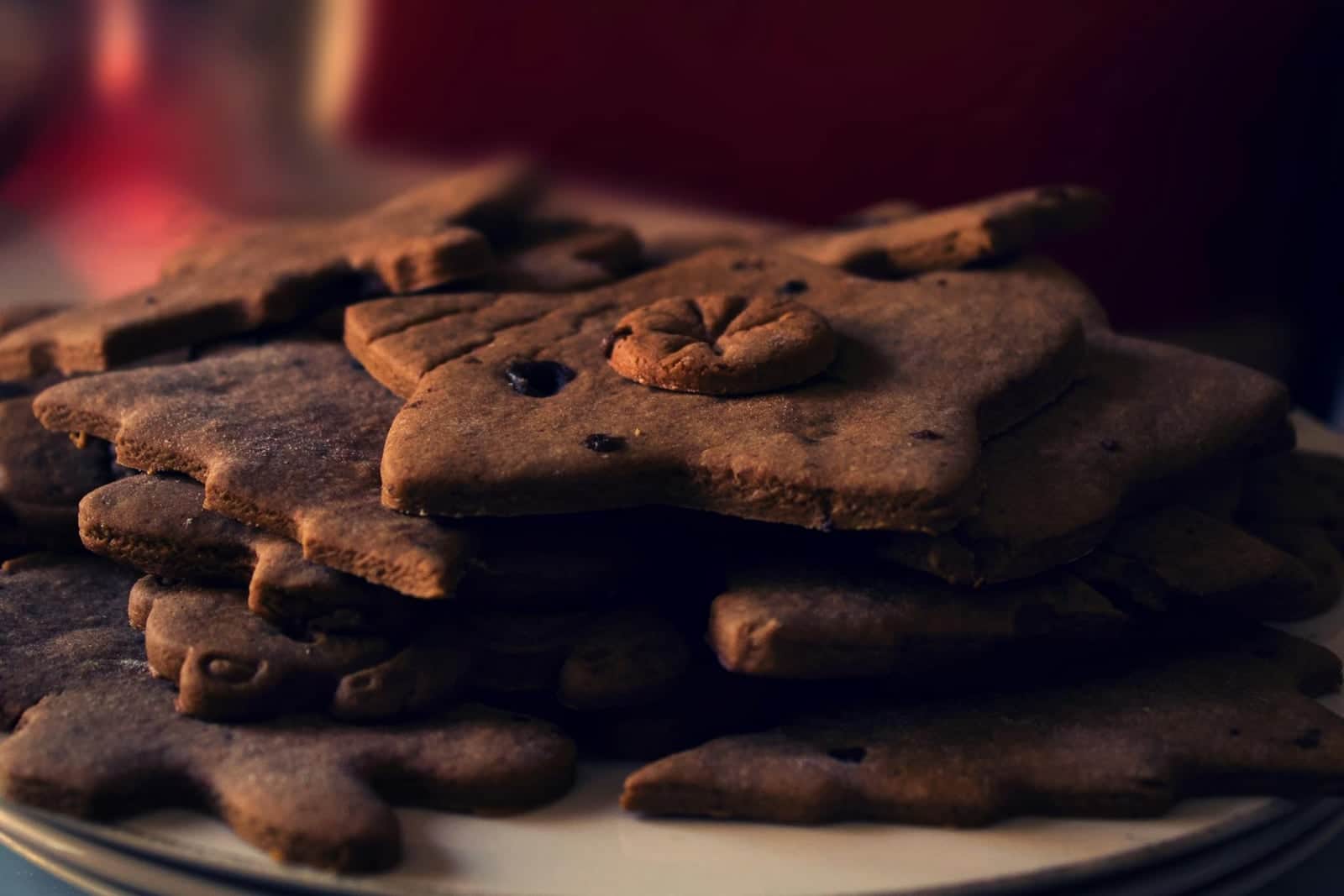 Classic gingerbread cookies stacked on a plate with warm holiday spices