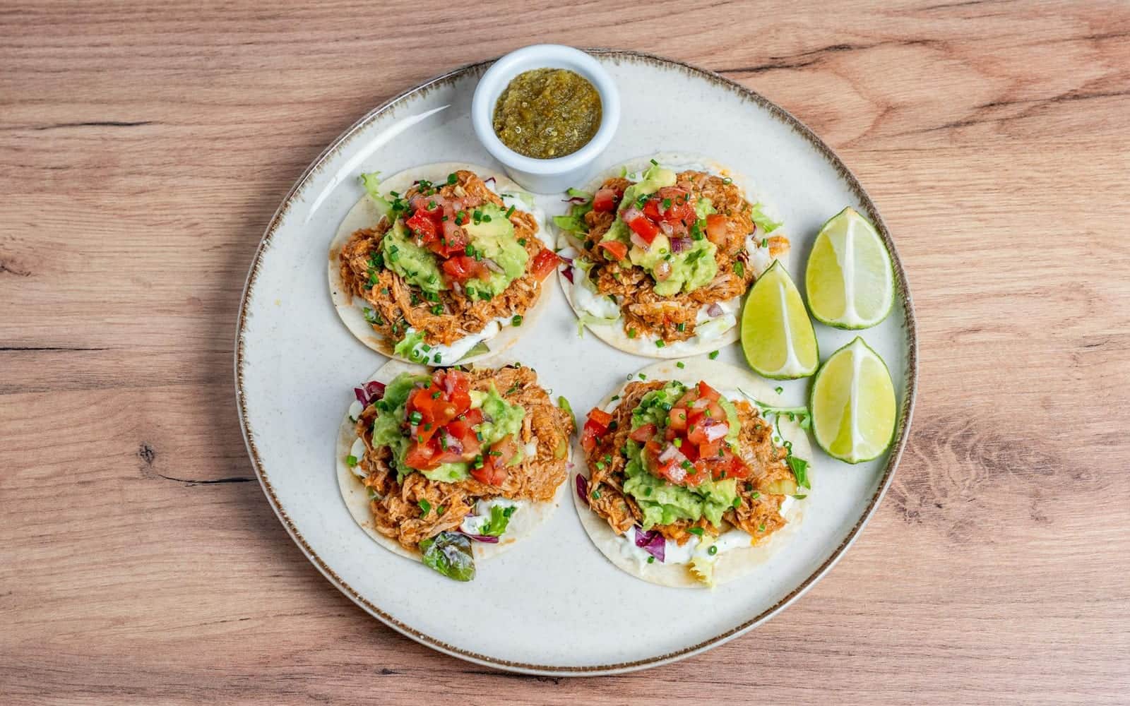 Dump-and-go salsa chicken-style tacos with tomato salsa, guacamole, and lime