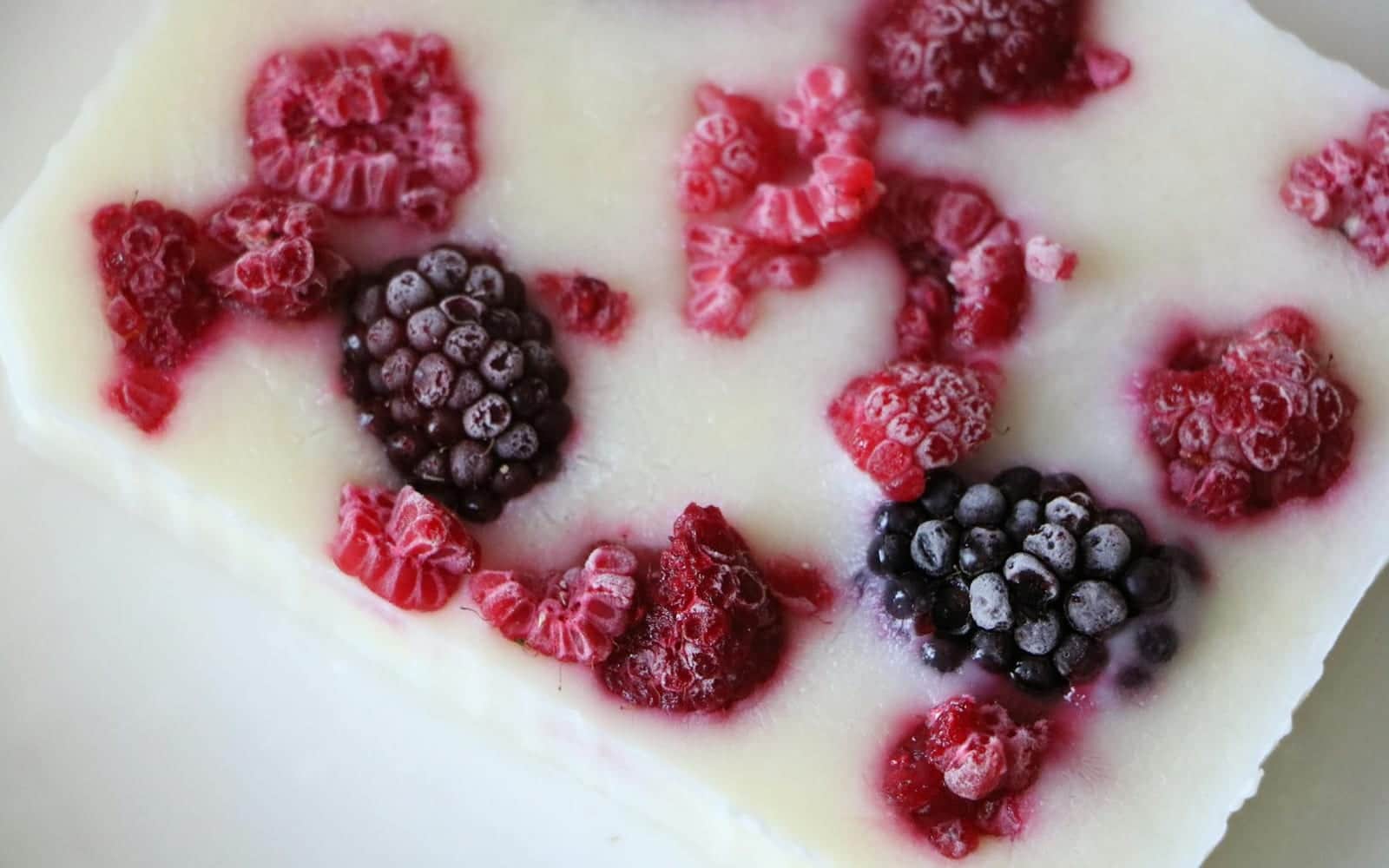 Frozen yogurt bites with berries set into a creamy yogurt bar