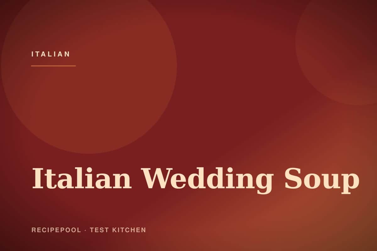 Bowl of Italian wedding soup with mini meatballs, pasta, and greens