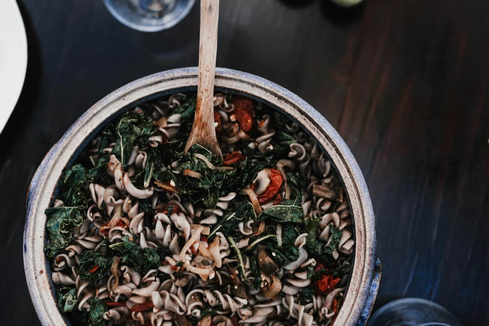 Italian kale pasta with beans, greens, and spiraled noodles in a deep pot