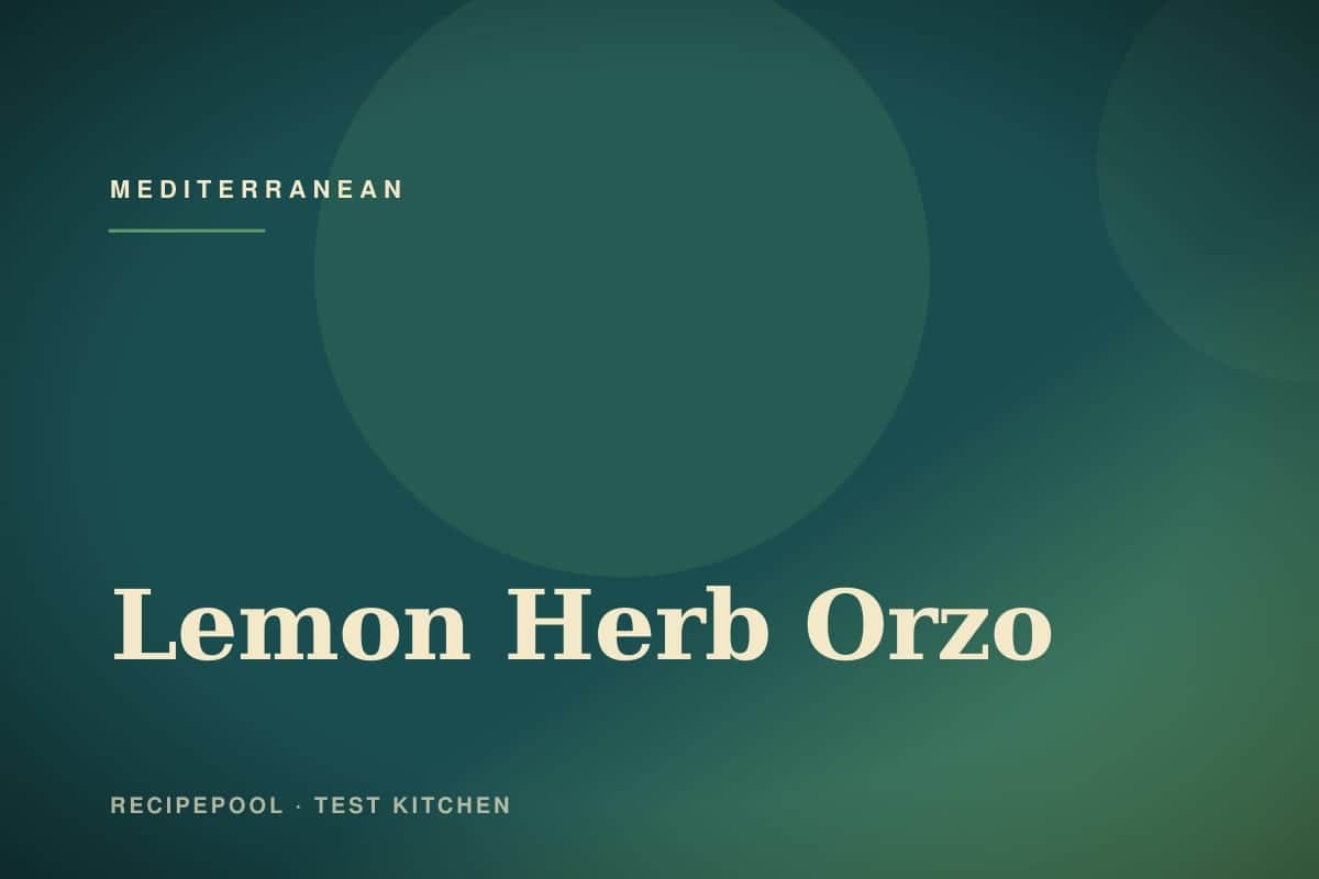 Bowl of lemon herb orzo salad with feta, cherry tomatoes, and fresh herbs