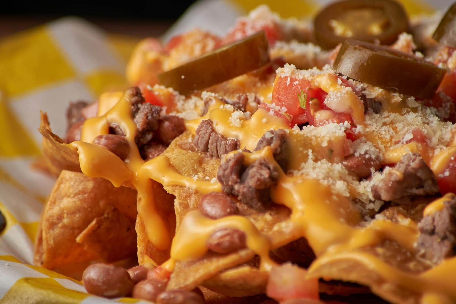 Loaded nachos supreme with melted cheese, beans, jalapenos, and toppings