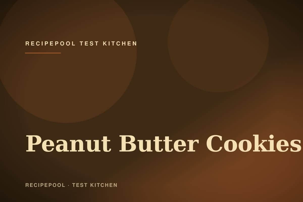 Peanut butter cookies with classic crosshatch pattern on a baking sheet