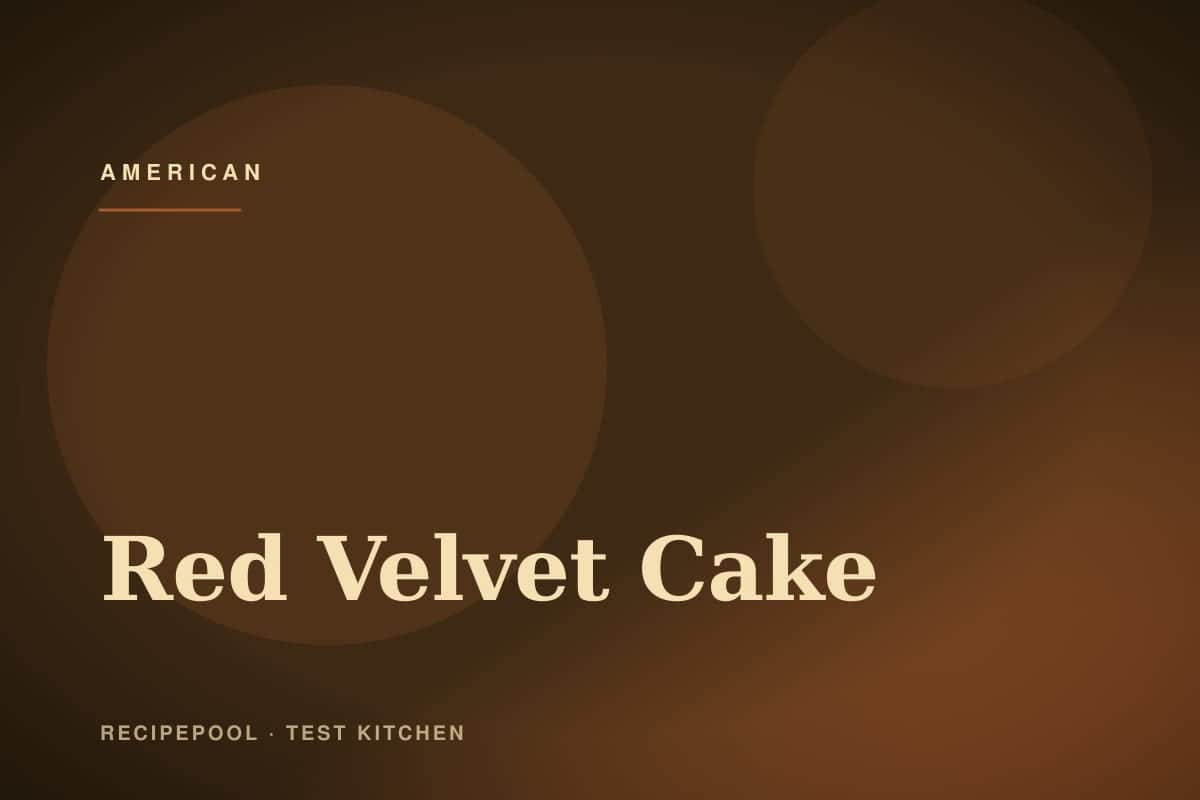 Tall red velvet layer cake with white cream cheese frosting on a cake stand