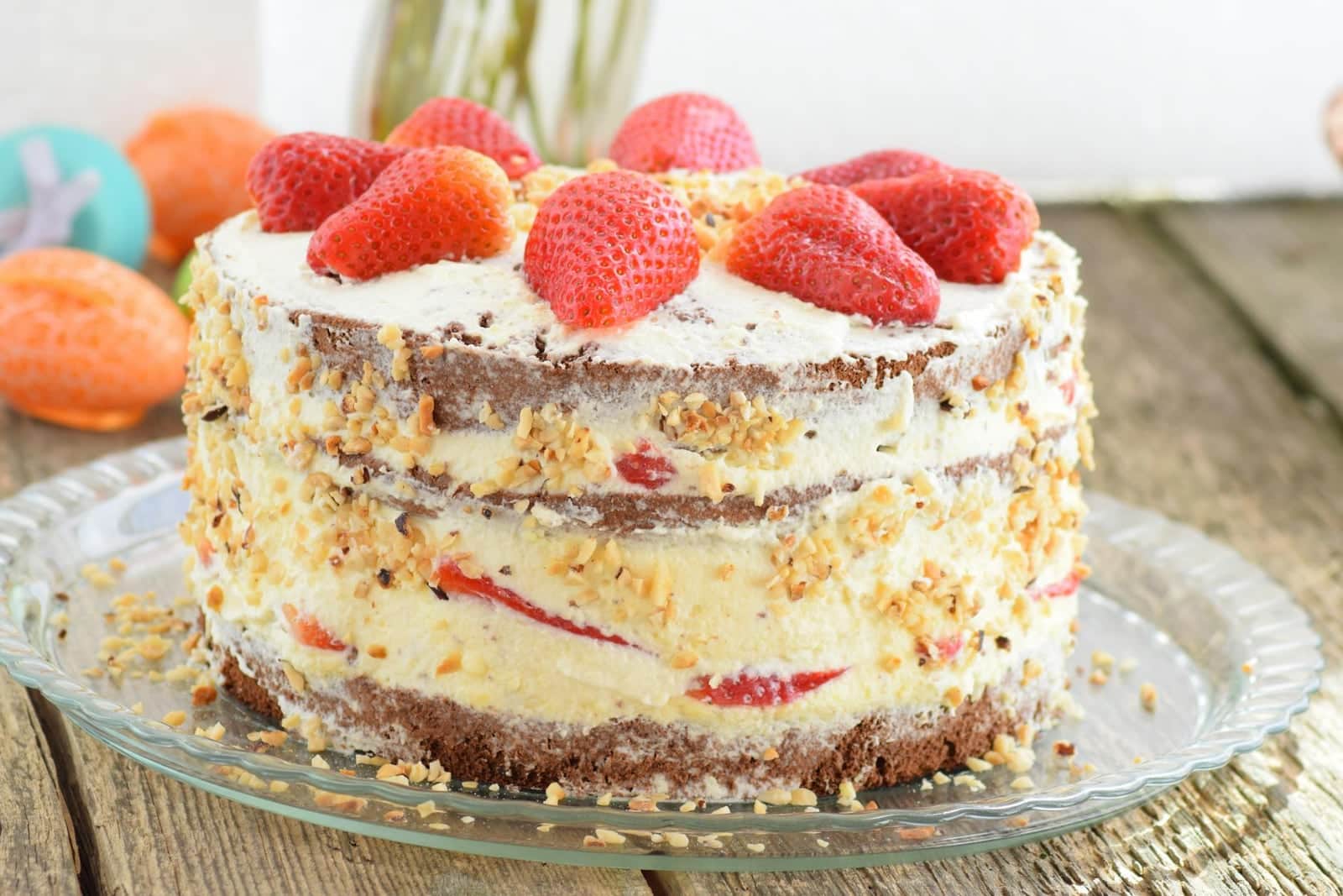 Strawberry layer cake with cream, fresh strawberries, and visible cake layers