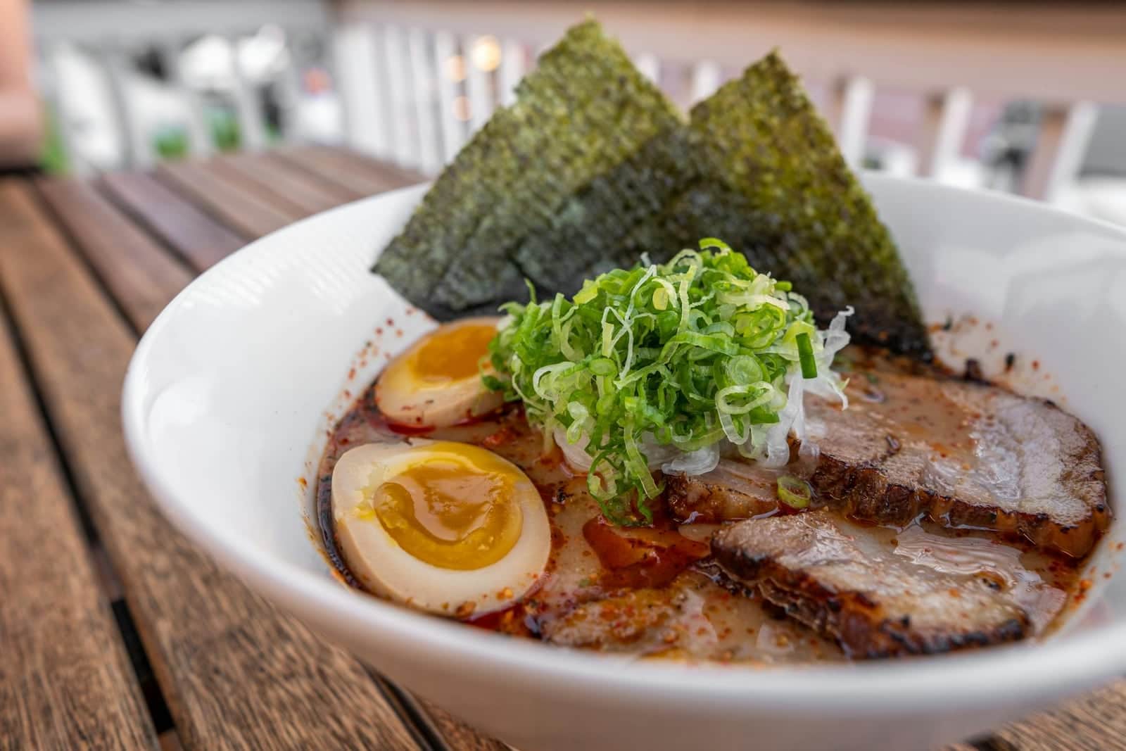 Tonkotsu ramen bowl with chashu pork, soft-boiled egg, noodles, scallions, and nori