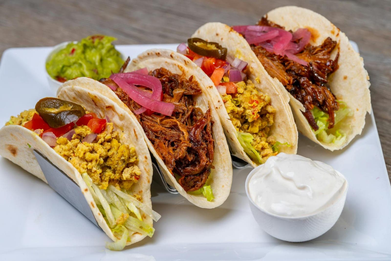 Austin-style breakfast tacos with eggs, salsa, guacamole, pickled onion, and tortillas