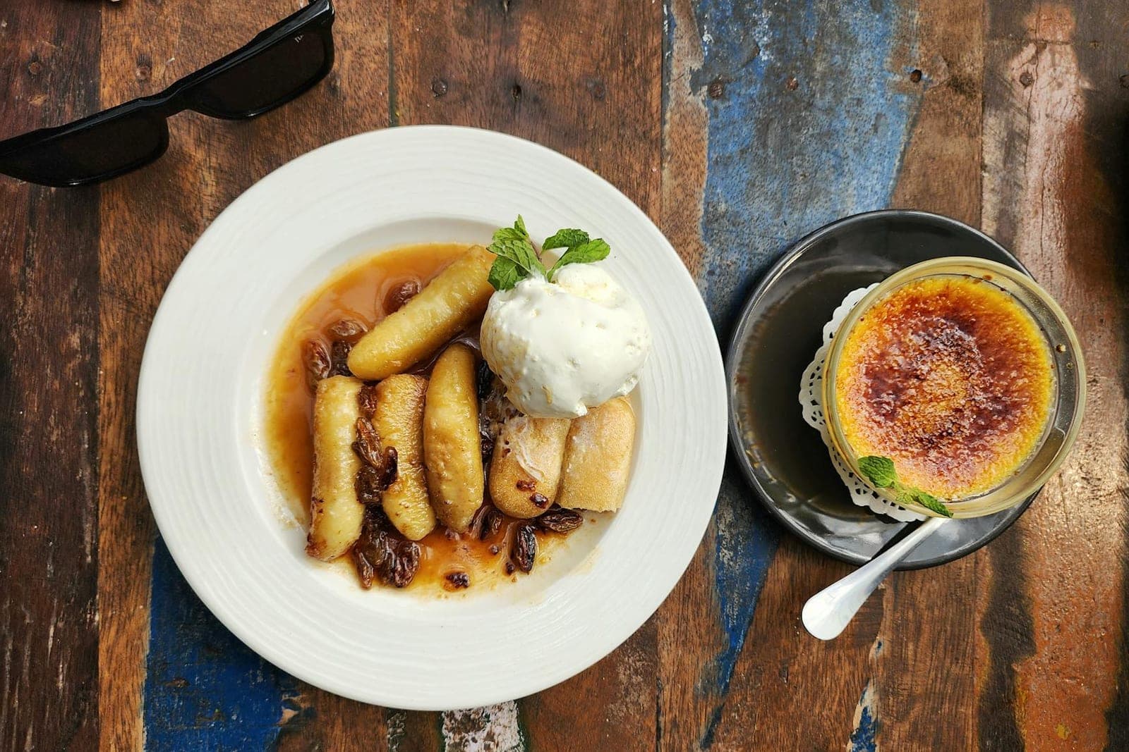 Bananas Foster-style caramelized banana dessert with vanilla ice cream on a white plate