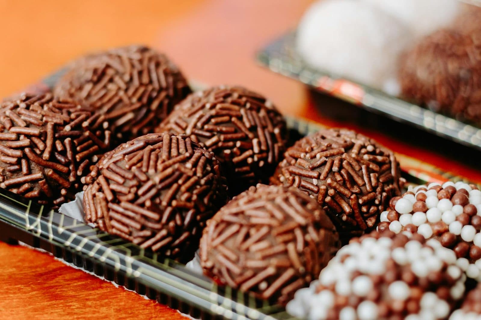 Brigadeiros chocolate truffles coated in sprinkles and arranged for serving