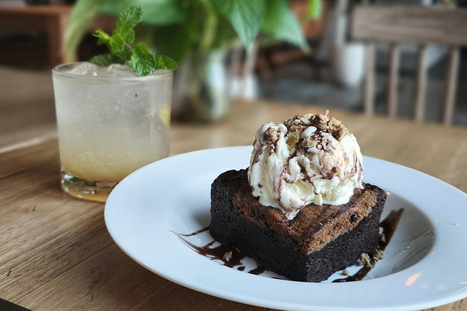 Warm brownie sundae topped with vanilla ice cream, chocolate sauce, and whipped cream