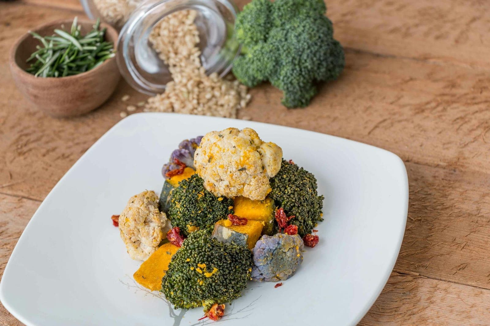 Charred broccolini-style roasted vegetables with lemon and garlic on a white plate