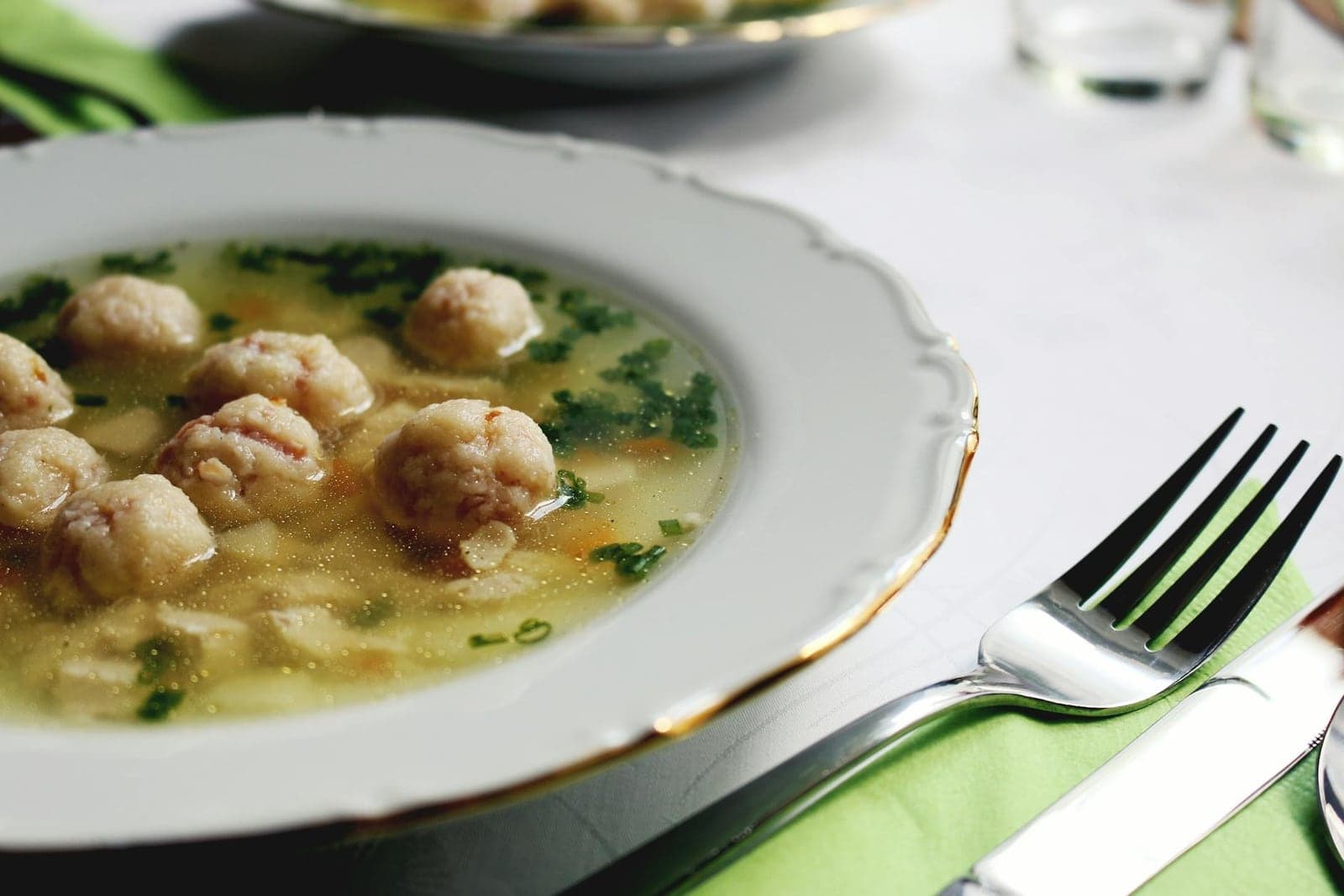 Chicken and dumplings soup with dumplings in a light broth and herbs