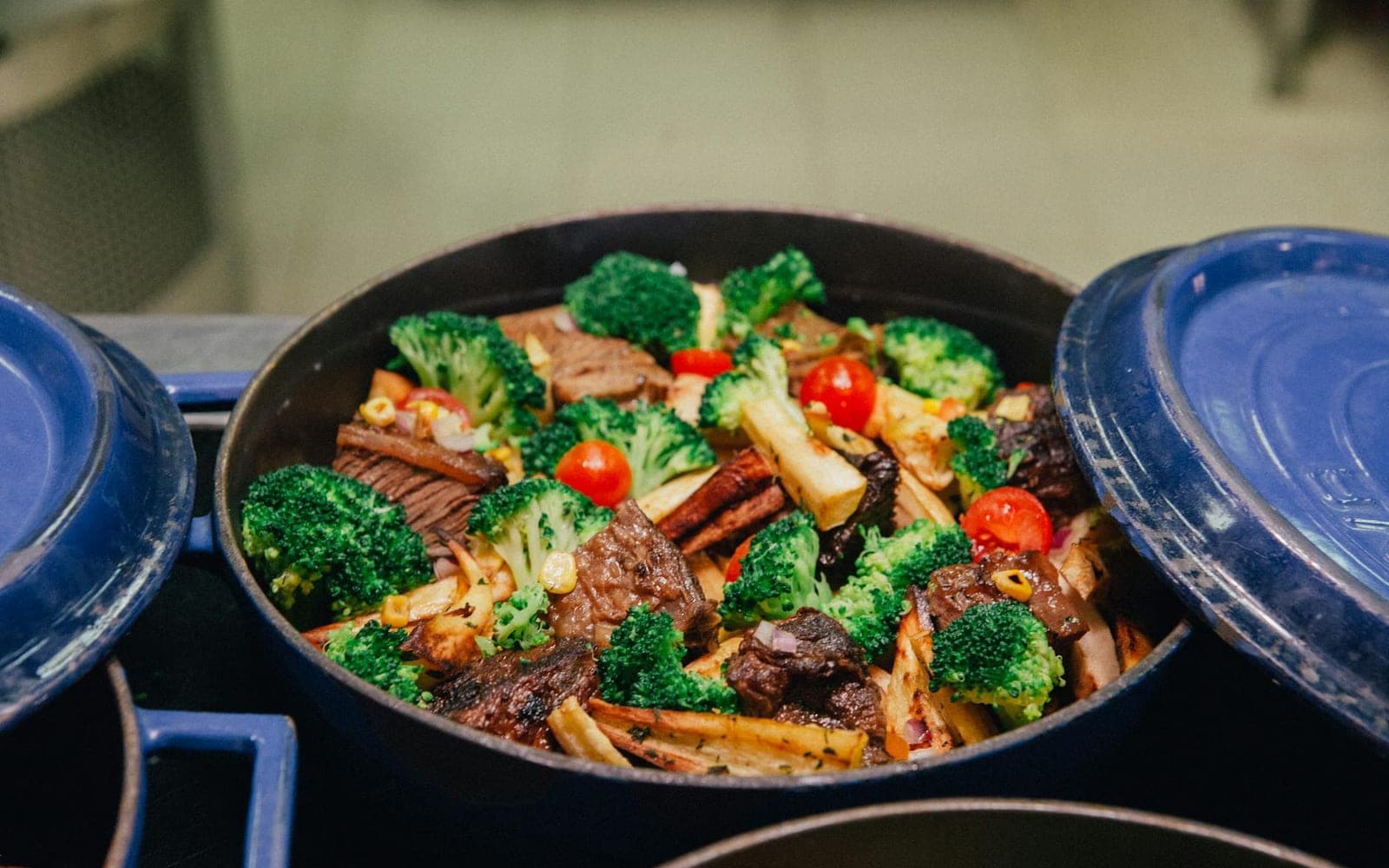Chicken broccoli rice casserole-style baked dish with broccoli, rice, and chicken in a blue pot