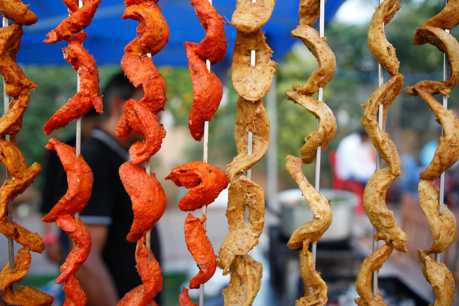 Chicken tikka skewers with red-orange spiced chicken pieces cooked on skewers