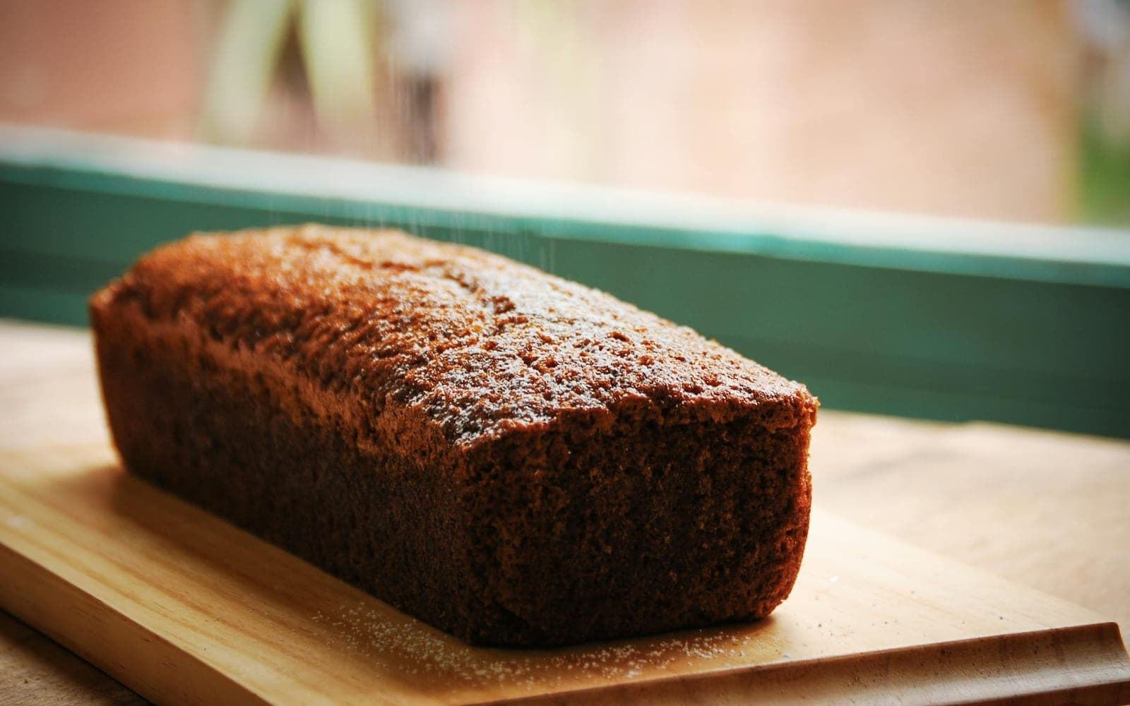 Chocolate banana bread loaf on a wooden cutting board