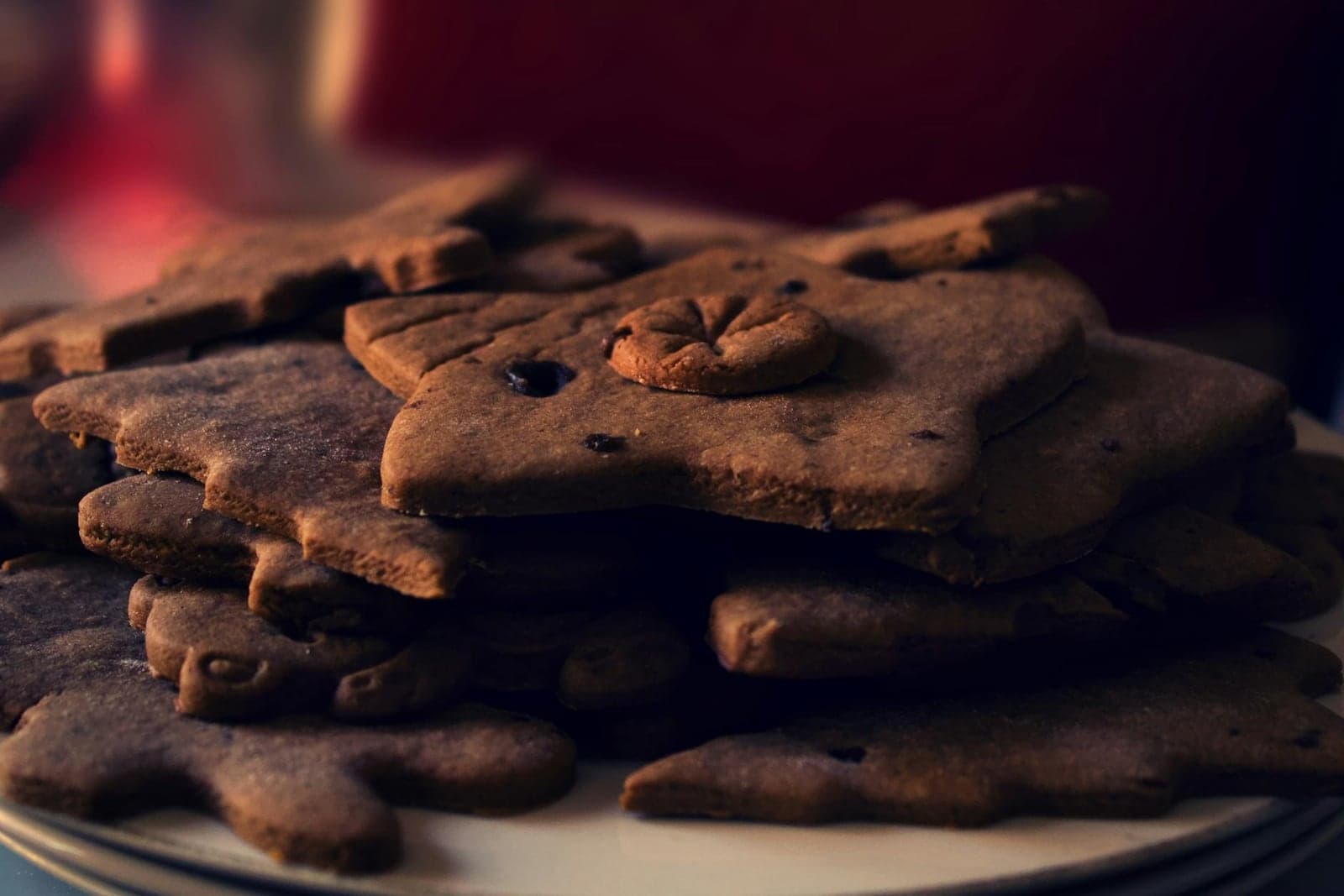 Classic gingerbread cookies stacked on a plate with warm holiday spices