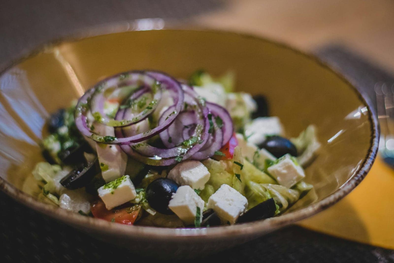 Classic Greek salad with cucumber, feta, black olives, red onion, and herbs