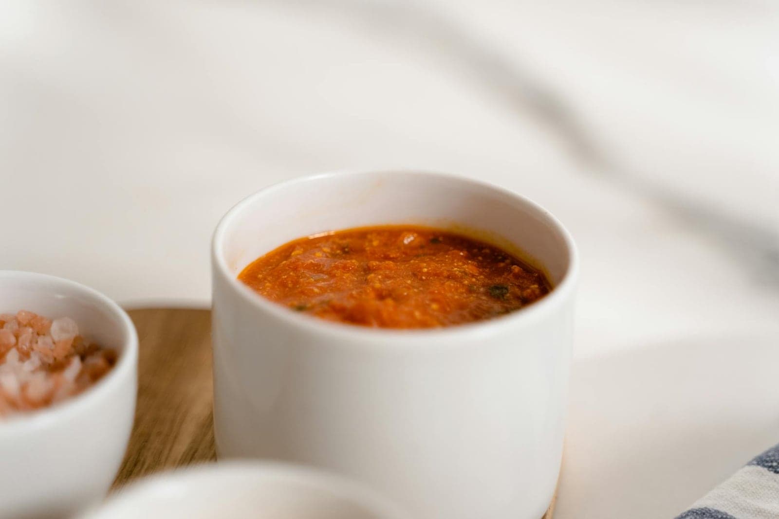 Classic marinara sauce in a white cup with a tomato-rich red color