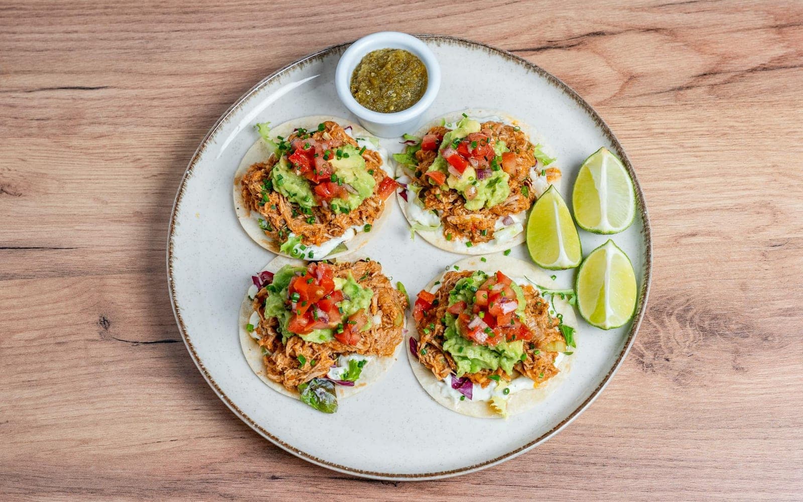 Dump-and-go salsa chicken-style tacos with tomato salsa, guacamole, and lime