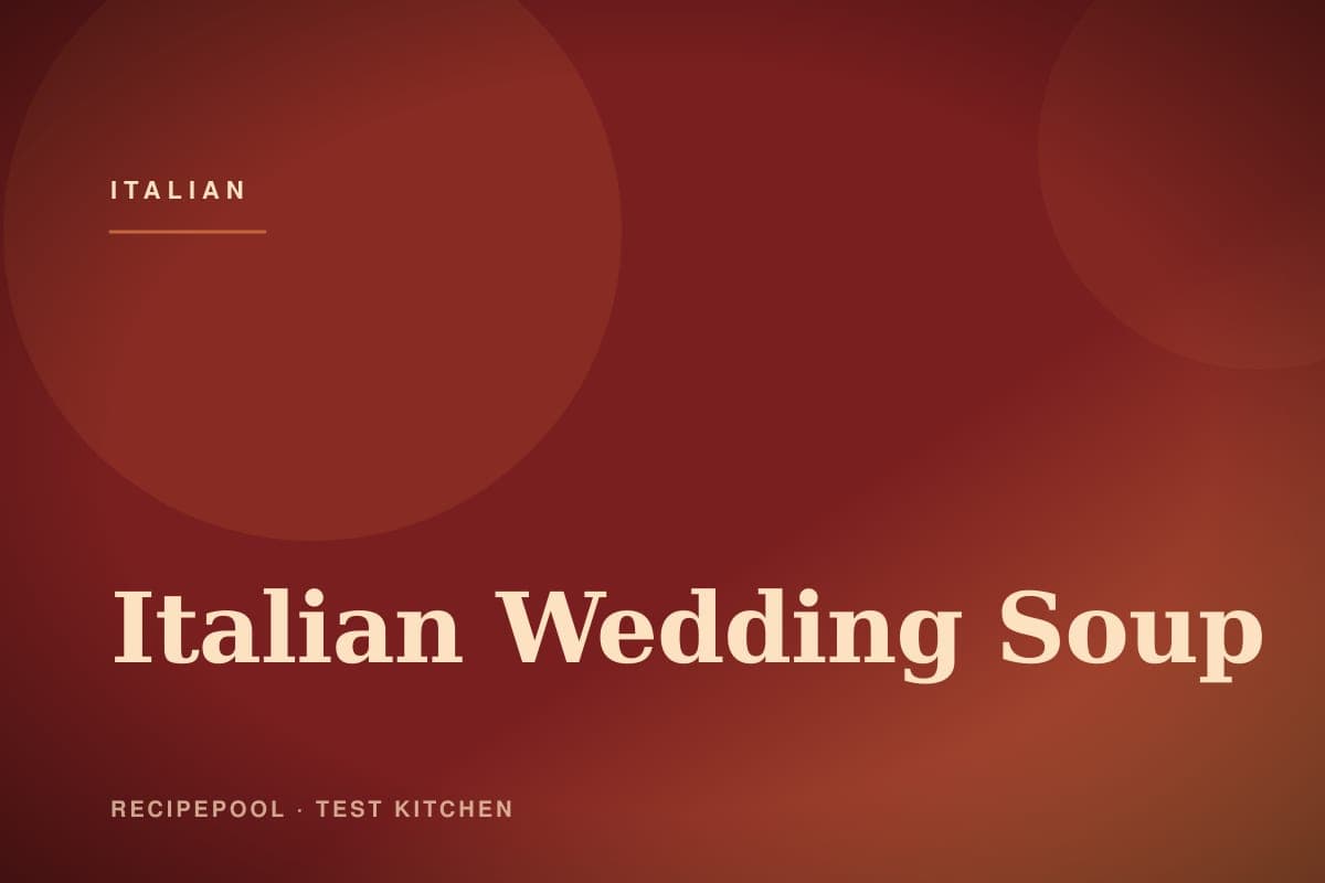 Bowl of Italian wedding soup with mini meatballs, pasta, and greens
