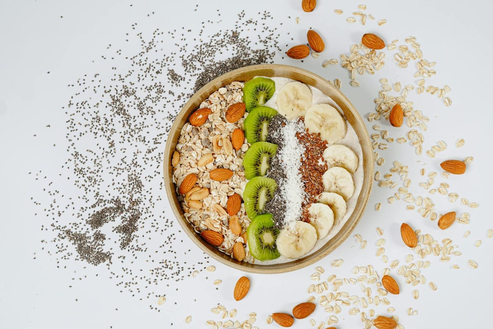 Matcha overnight oats breakfast bowl with kiwi, banana, almonds, and chia seeds