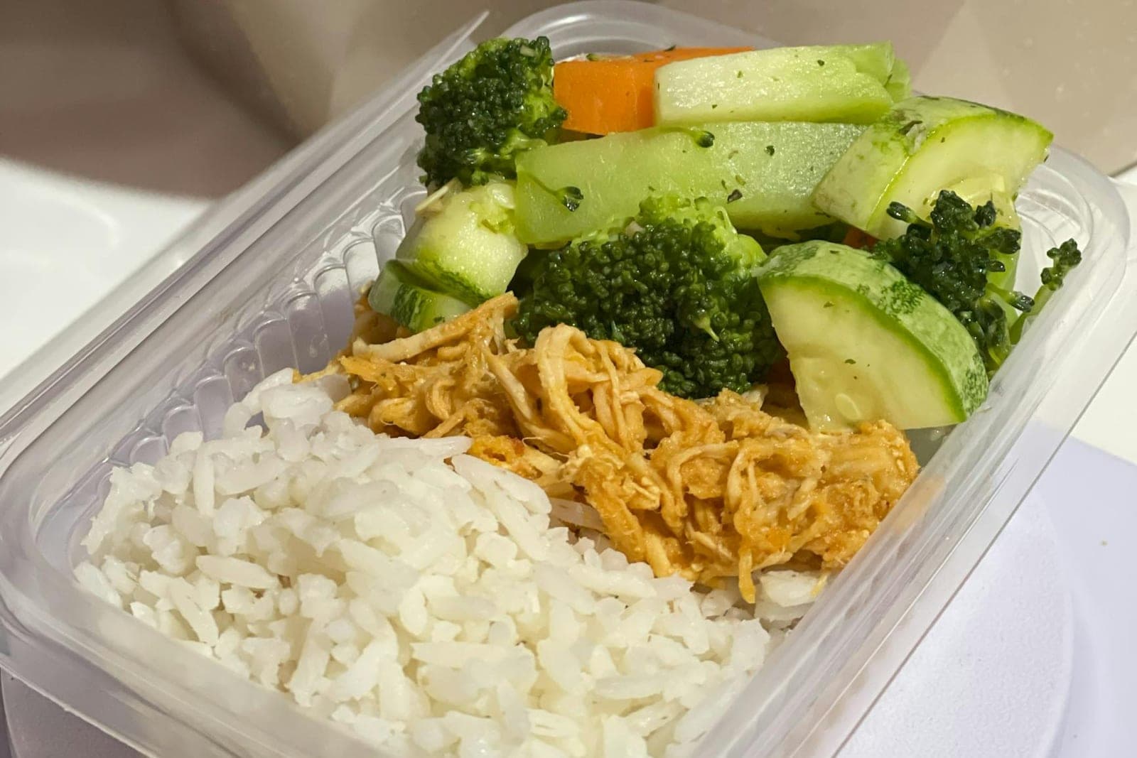 Korean chicken rice meal prep box with shredded chicken, rice, and vegetables