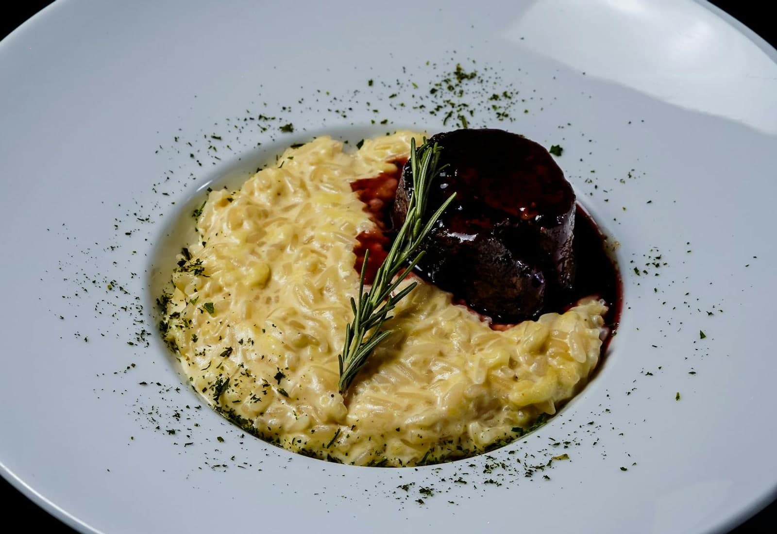 Osso buco alla Milanese-style braised meat served over creamy risotto with rosemary