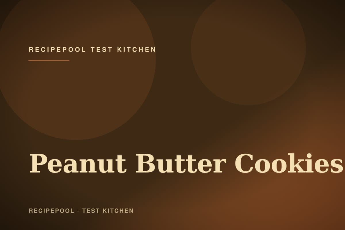 Peanut butter cookies with classic crosshatch pattern on a baking sheet