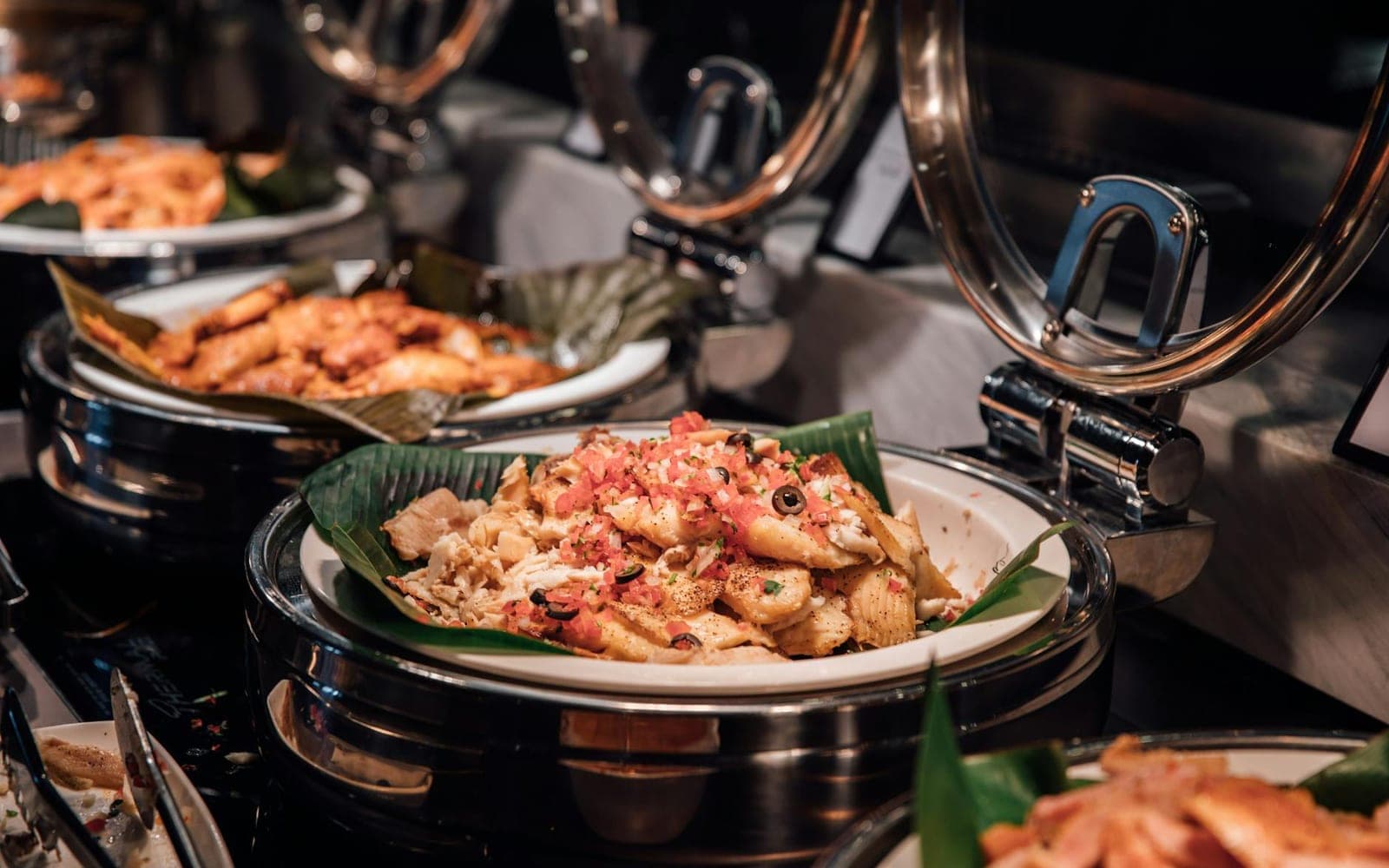 Penne arrabbiata-style tomato pasta with red sauce and garnish at a buffet