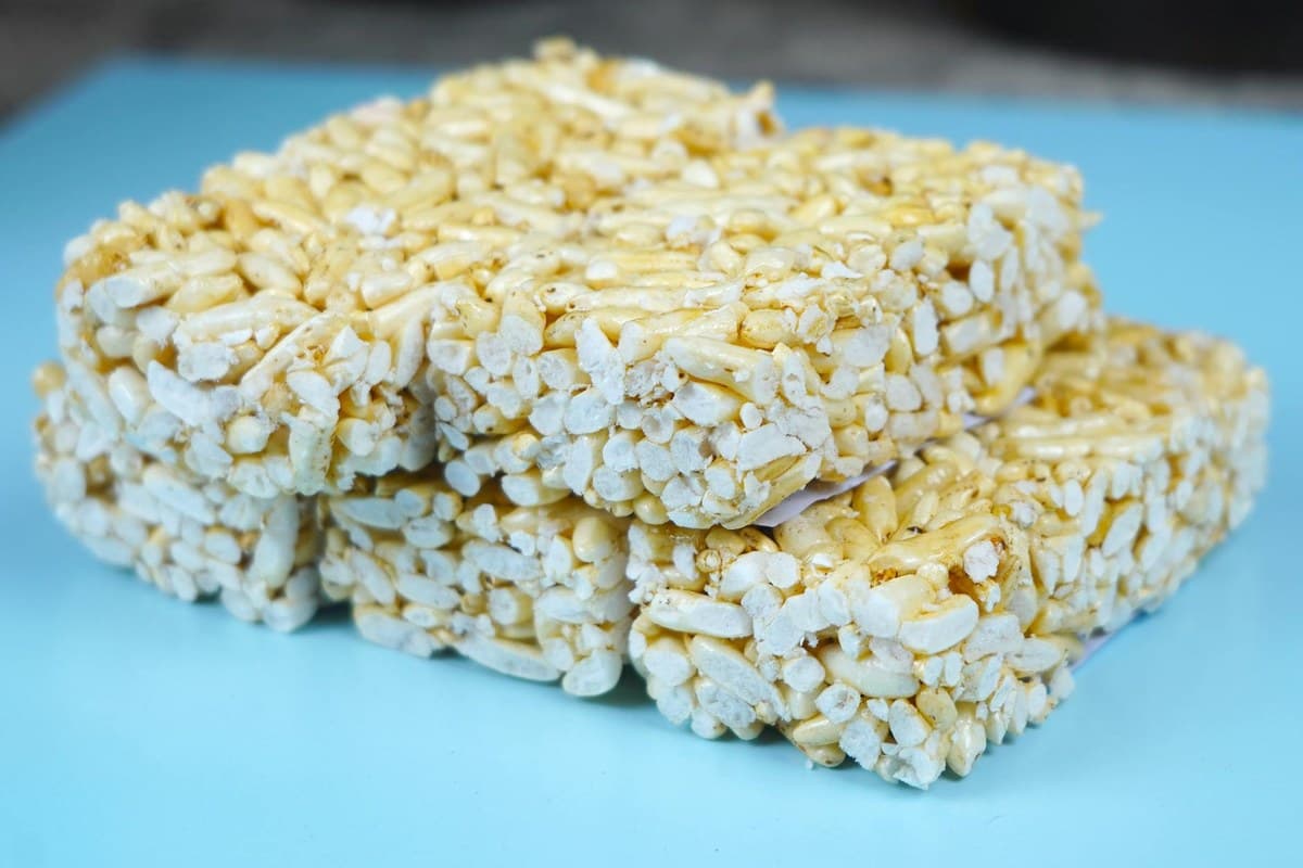 Stacked brown butter rice krispie bars on a blue surface