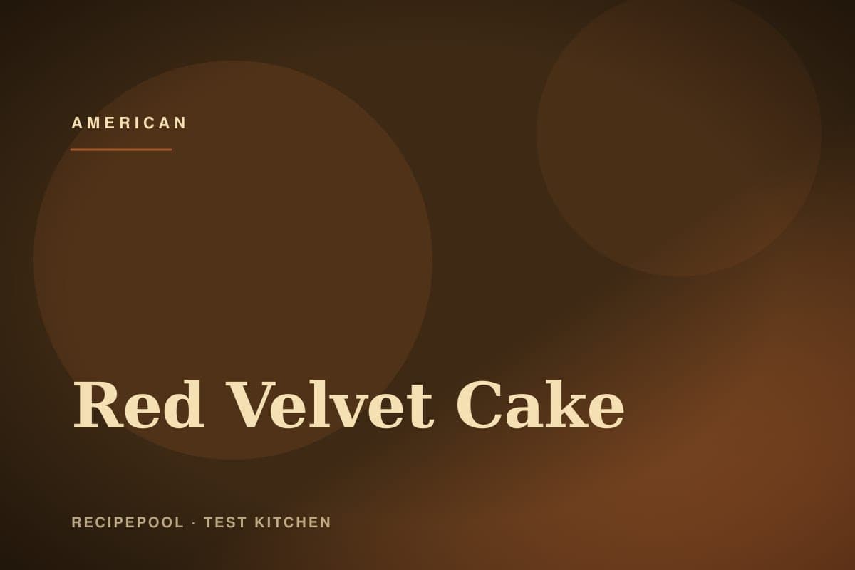 Tall red velvet layer cake with white cream cheese frosting on a cake stand