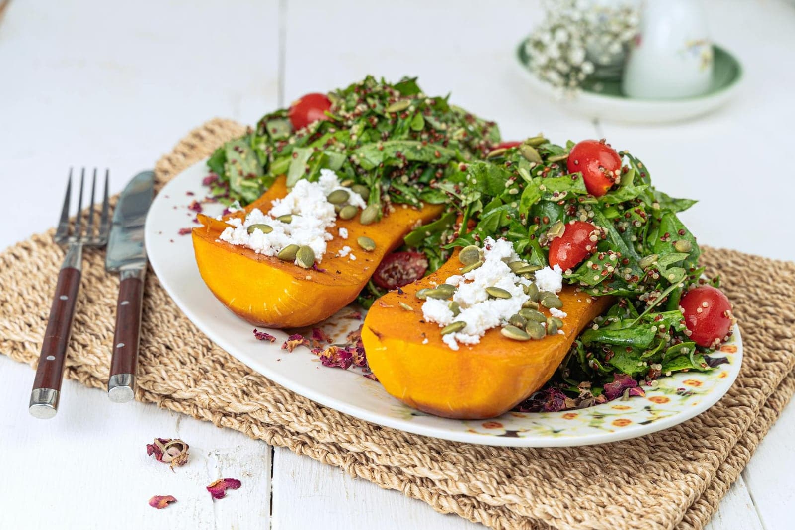 Roasted delicata squash salad with greens, cherry tomatoes, feta, and herbs