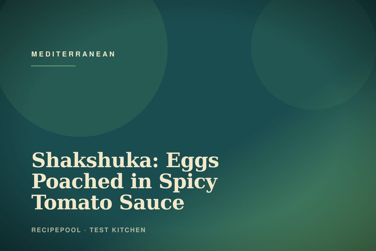 Skillet of shakshuka with eggs poached in spicy tomato sauce topped with fresh herbs