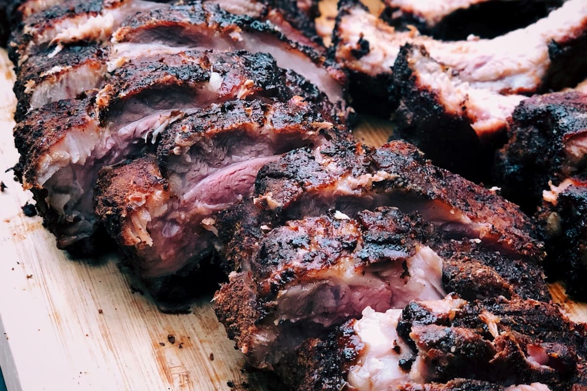 Slow cooker pulled pork piled on a brioche bun with coleslaw and BBQ sauce