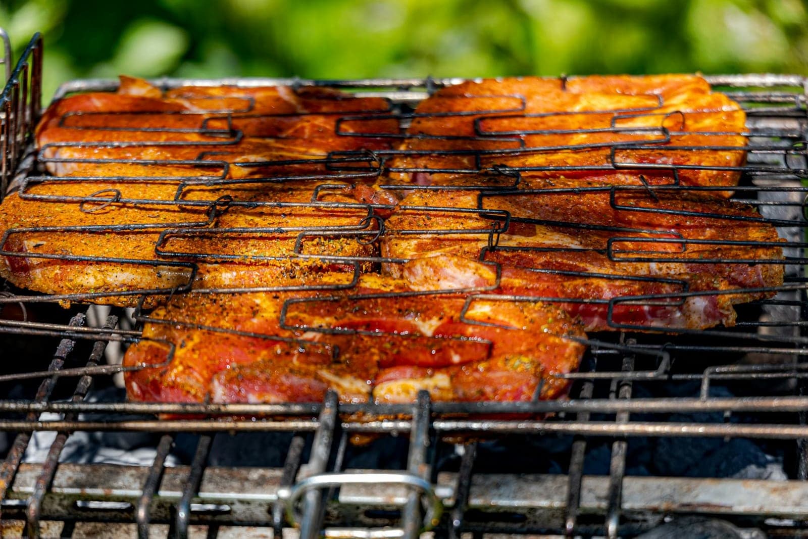 Soy ginger glazed pork chops charred on a grill with a glossy savory glaze