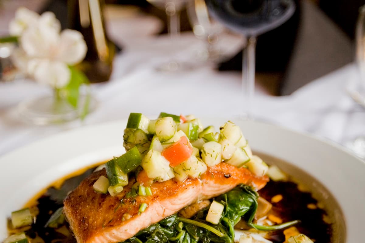 Teriyaki salmon rice bowl with glossy glazed salmon, rice, edamame, cucumber, and avocado