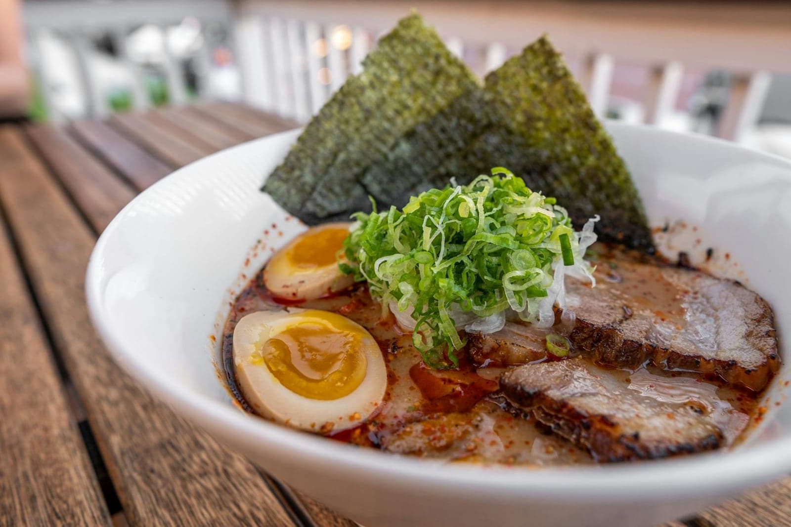 Tonkotsu ramen bowl with chashu pork, soft-boiled egg, noodles, scallions, and nori