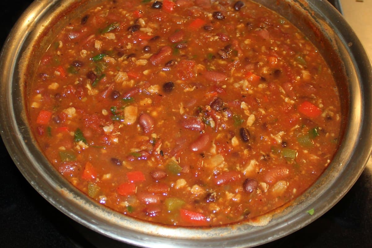 A pot of hearty vegetarian chili with beans, peppers, and tomatoes