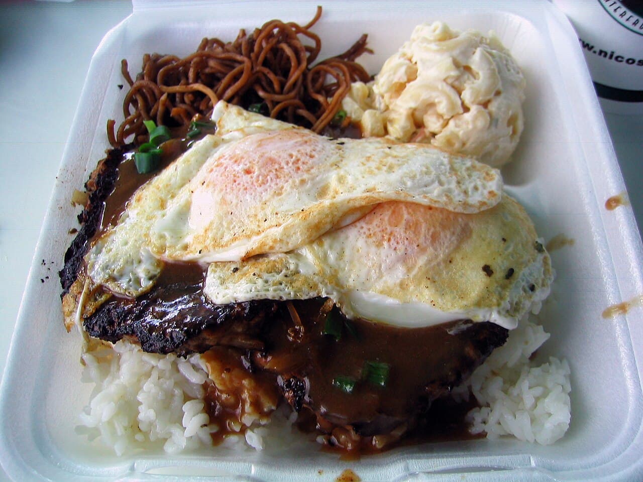Loco moco with beef patty over rice topped with brown gravy and a fried egg