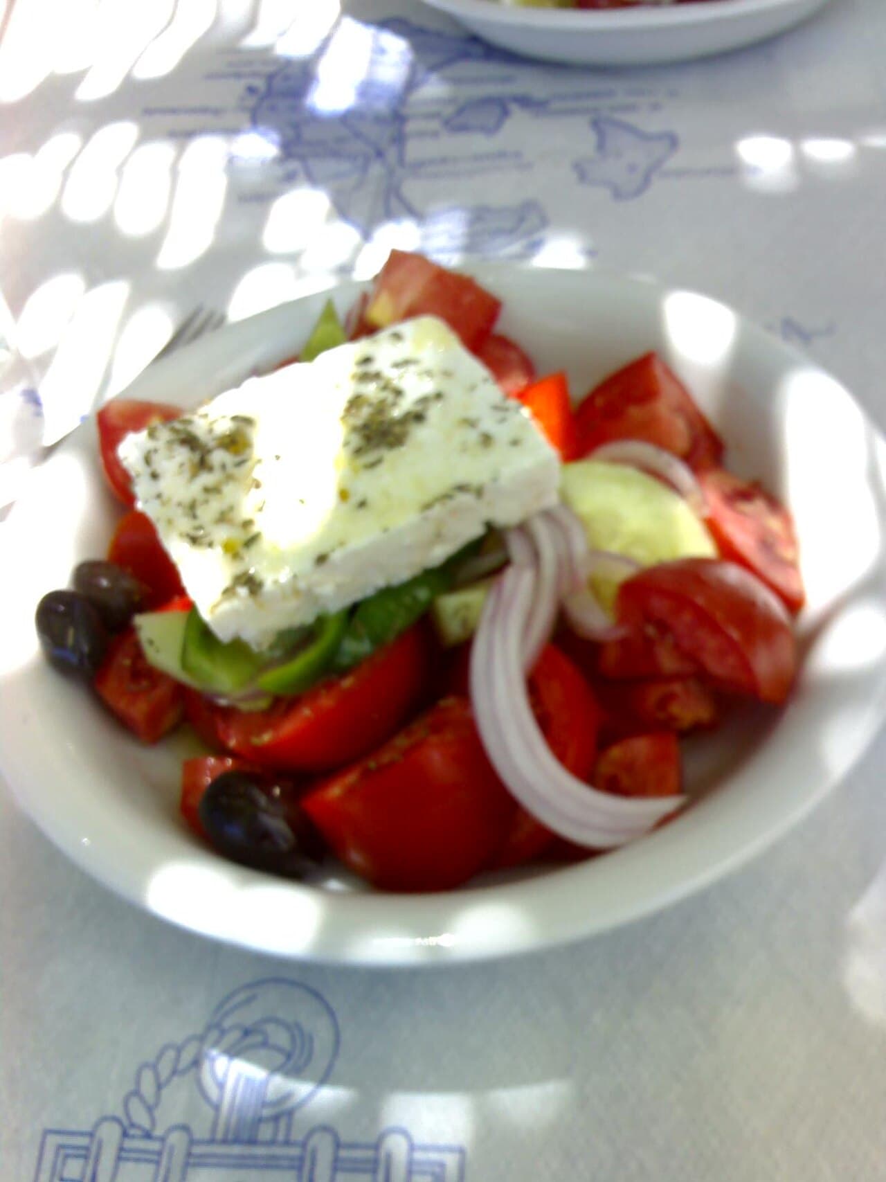 Greek salad with tomatoes, cucumber, red onion, olives, and feta